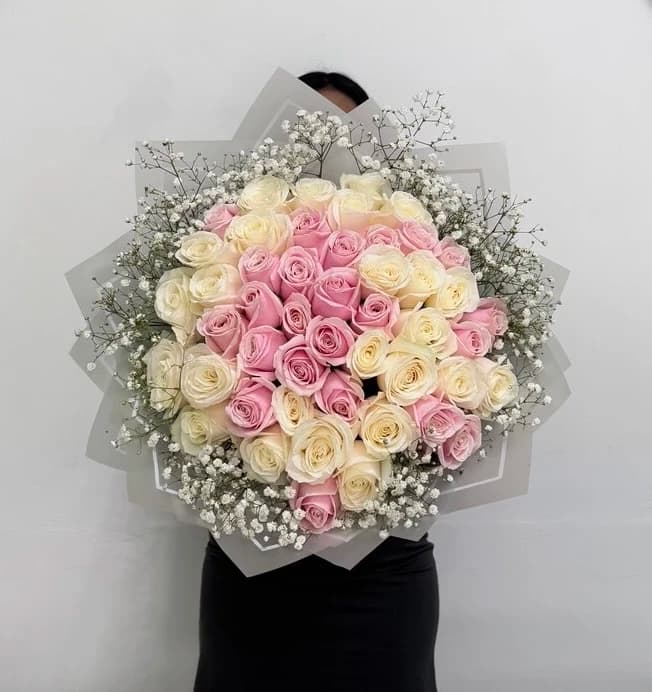 Classic romance reimagined: fifty-one vibrant Holland roses with delicate baby's breath.