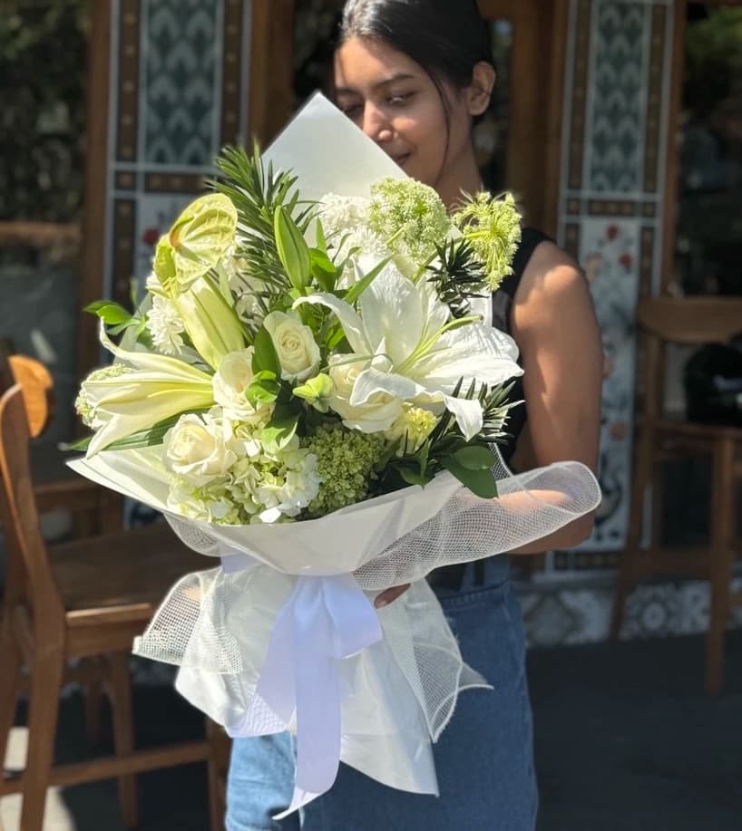 An elegant and sophisticated bouquet featuring a beautiful assortment of white and green blooms.